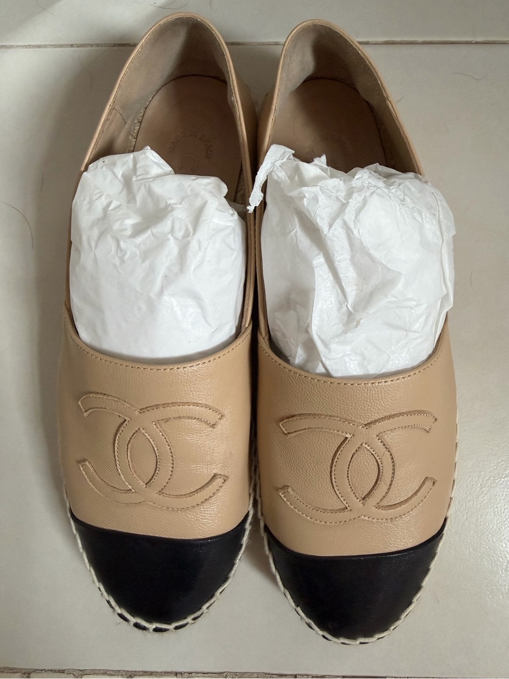 CHANEL Beige Leather Flats with Black Cap Toe and Embossed CC